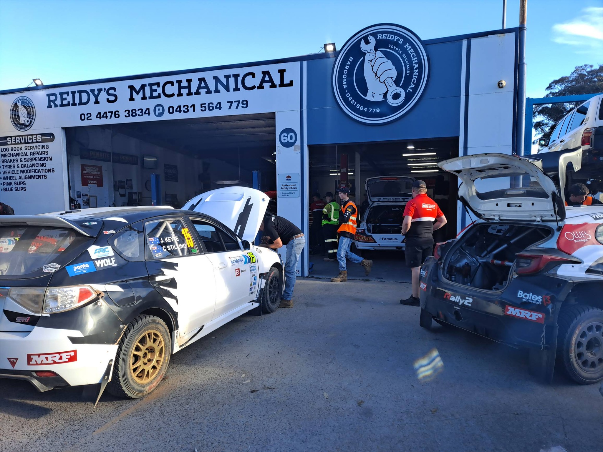 Australian Rally Championship cars and their crews outside the Reidy's Mechanical workshop during the Narooma Forest Rally