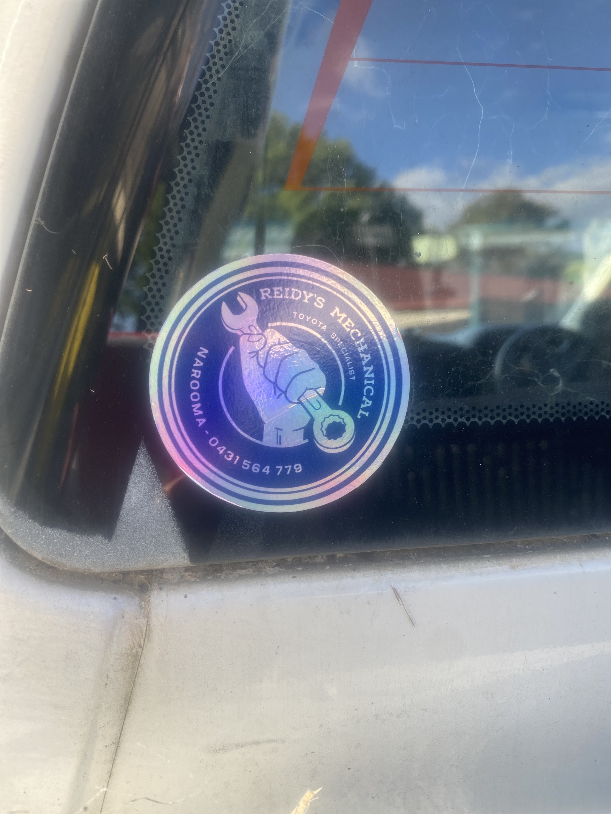 A Reidy's Mechanical sticker on a customer's rear window
